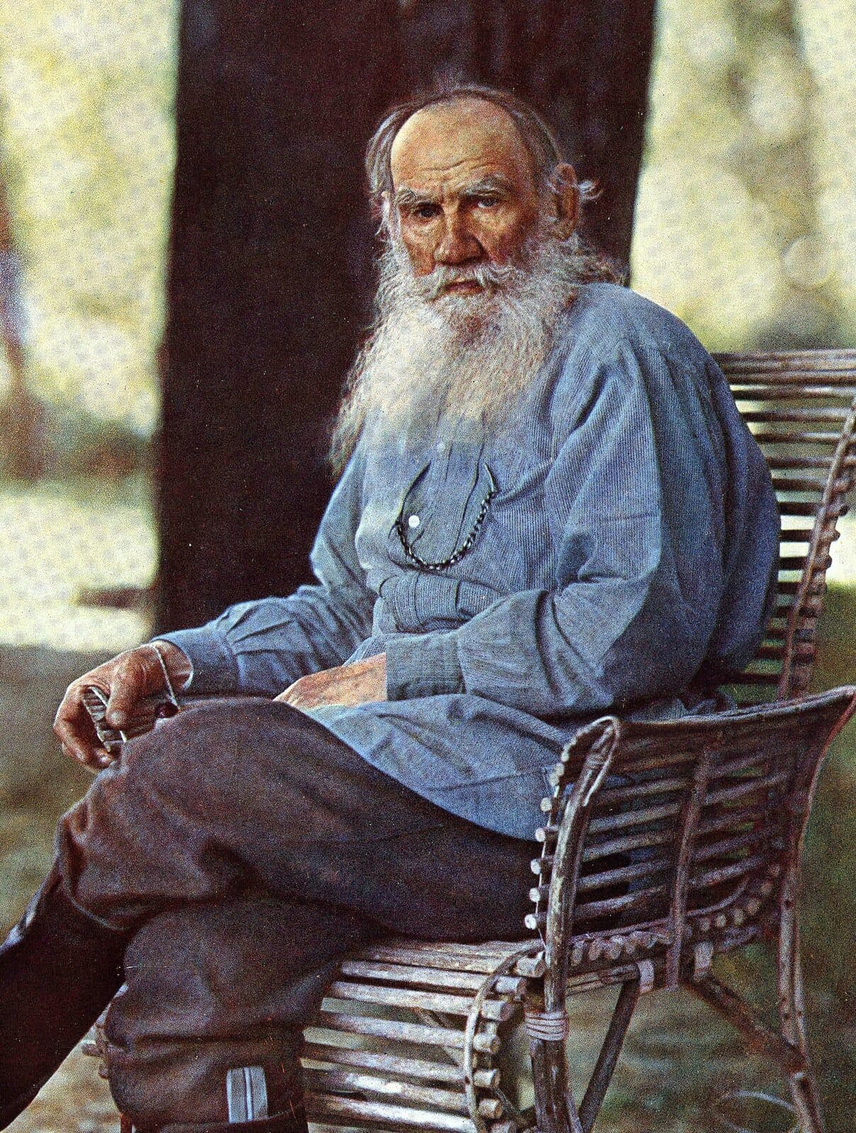 Leo Tolstoy seated in a garden chair